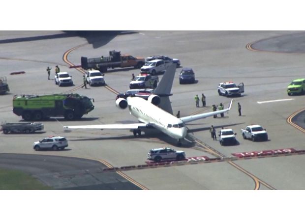 A small plane's tail is damaged by a larger plane during takeoff.