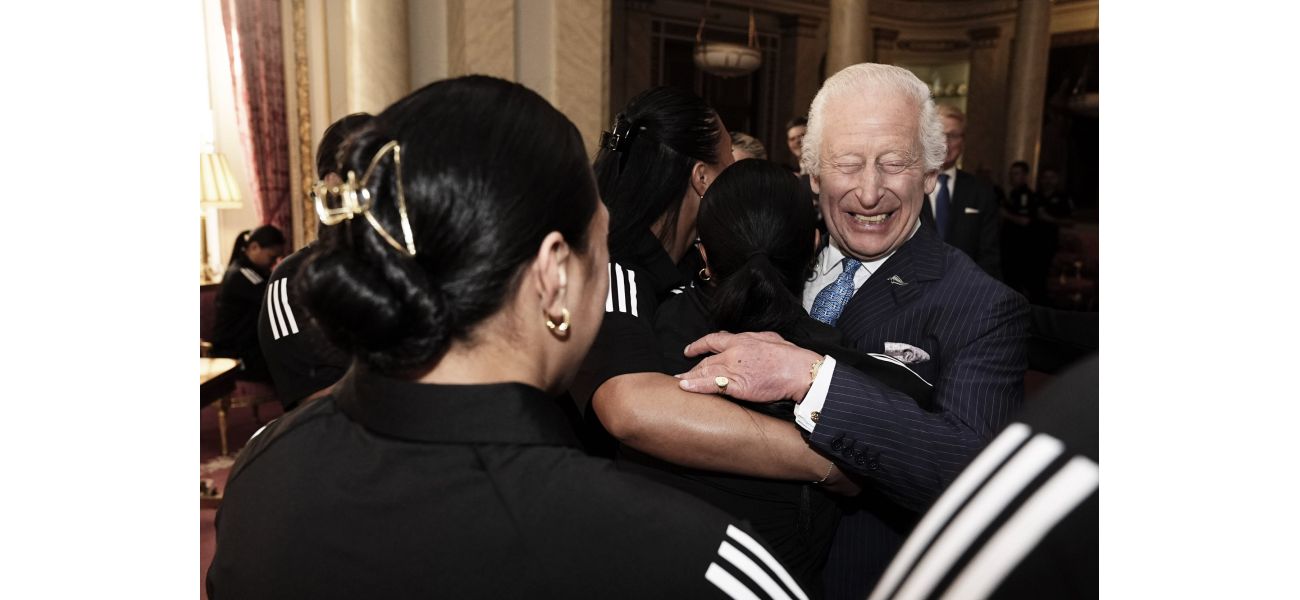 The rugby star's big hug made King Charles very happy.
