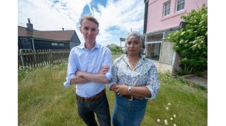 A couple who were forbidden from viewing their neighbor's house are no longer facing charges.
