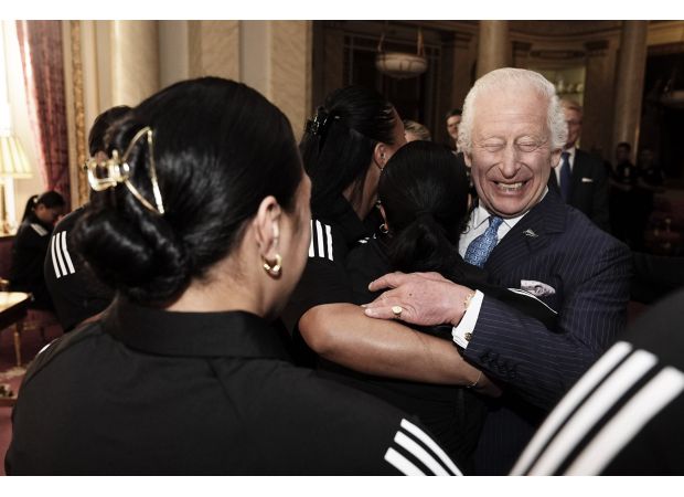 The rugby star's big hug made King Charles very happy.