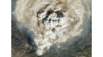 California wildfire appears as detonated bomb in space.