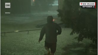 As cops hesitate, passerby jumps into floods for daring rescue.