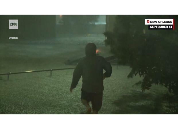 As cops hesitate, passerby jumps into floods for daring rescue.