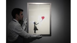 Two men accused of stealing famous Banksy painting from London art gallery.