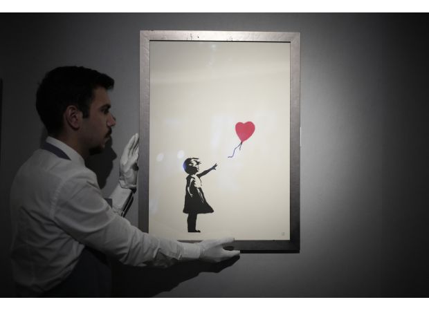Two men accused of stealing famous Banksy painting from London art gallery.