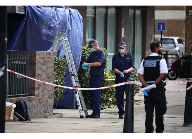 A woman in her 30s was fatally stabbed inside a flat and two individuals have been taken into custody.