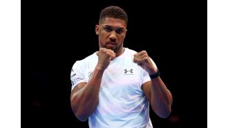 Boxer Anthony Joshua takes a swipe at someone who accused him of getting weak knees while sparring with Daniel Dubois.