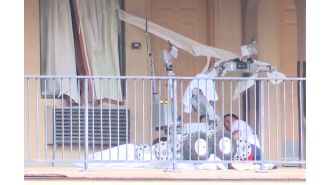A man battling a police robot is hit with tear gas and run over by it.