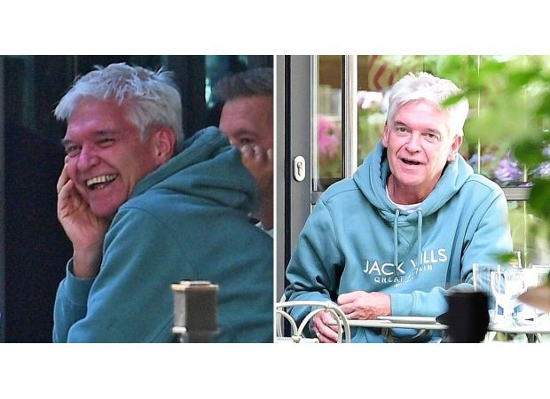Excited Phillip Schofield spotted wearing wedding ring with happy expression.