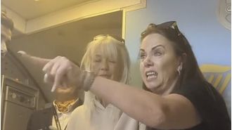 A passenger on Ryanair flight threatens to fight someone outside the plane in a profane outburst.