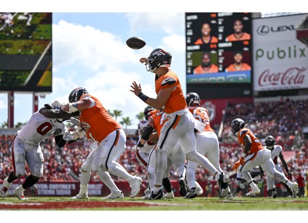 Broncos triumph over Buccaneers with 26-7 victory in photos.