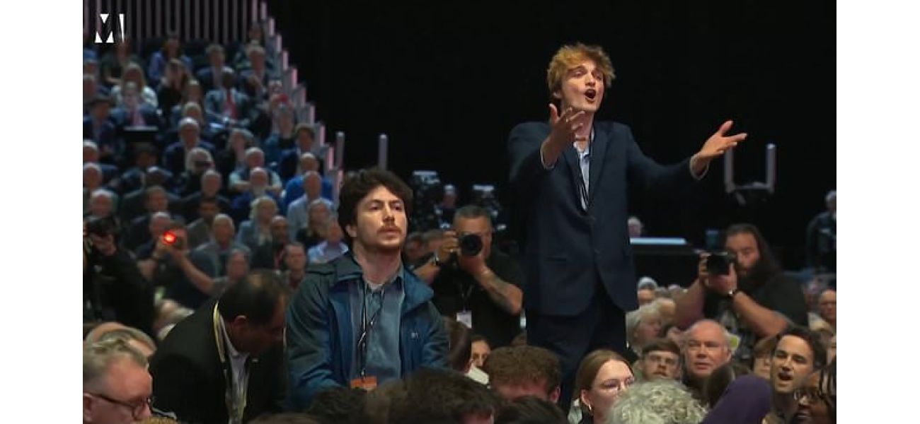 Security removed a heckler who interrupted the chancellor's speech.