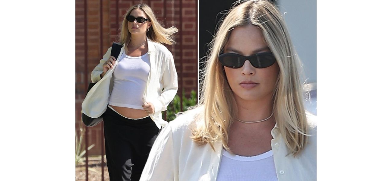 Margot Robbie, who is in her late stages of pregnancy, was spotted running errands while showing off her bare baby bump.