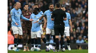 Man City's Kyle Walker expresses annoyance with referee after draw against Arsenal.