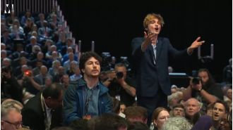 Security removed a heckler who interrupted the chancellor's speech.
