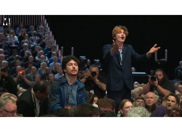 Security removed a heckler who interrupted the chancellor's speech.