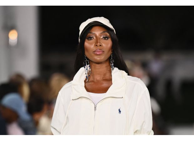 Supermodel Naomi Campbell loses charity role for using £7,800 of funds on luxury hotel stay.