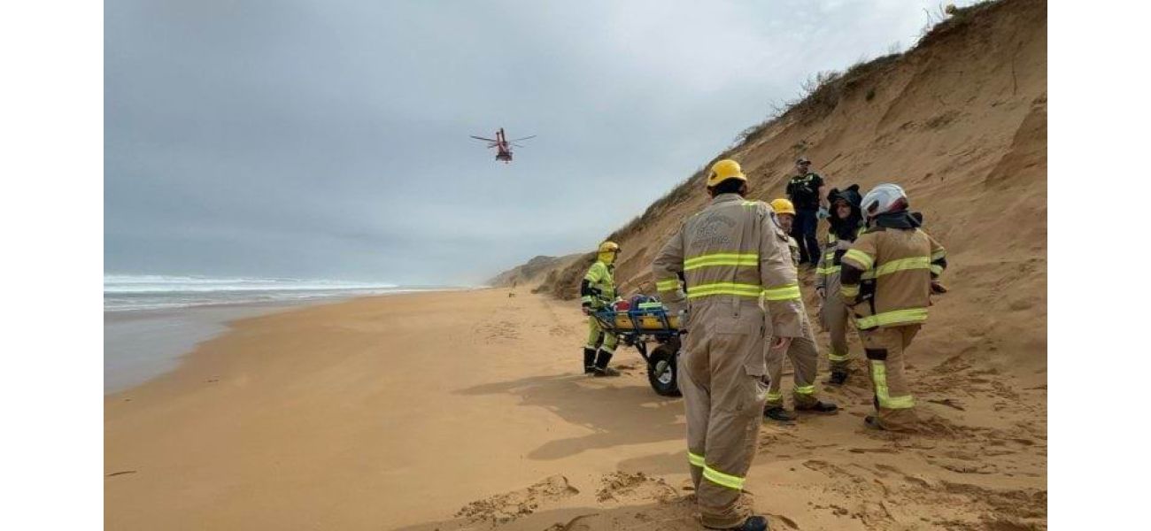 A man's legs are injured when his dogs pull him down a 30-meter sand dune.