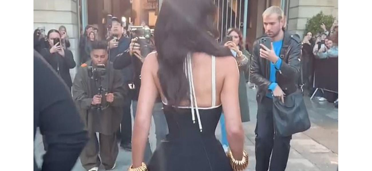 Kylie Jenner shows off her unrealistically small waist in a tightly fitting corset dress.