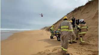 A man's legs are injured when his dogs pull him down a 30-meter sand dune.