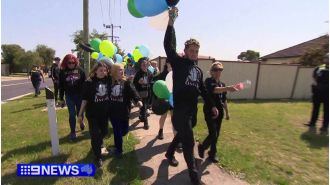 A large group of people walks through Melbourne's streets to pay tribute to a victim of knife crime.