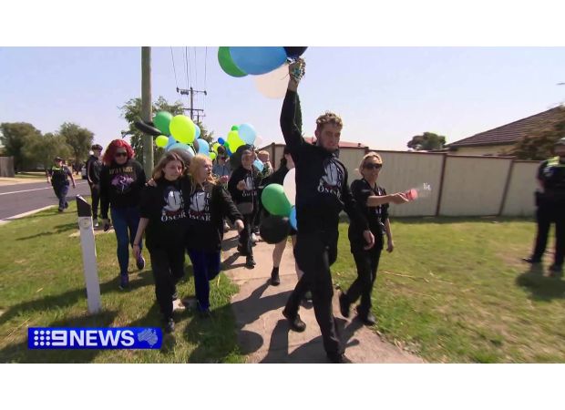 A large group of people walks through Melbourne's streets to pay tribute to a victim of knife crime.