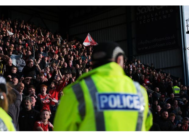 Soccer player faints in front of worried teammates during halftime in the locker room.