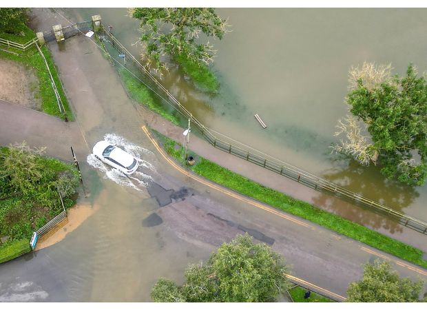 Rivers overflowing due to heavy rain; flood warnings still in effect.