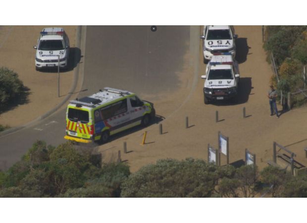 A woman has died after being swept off rocks with a group near Melbourne.