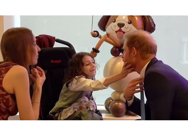 Young boy steals show from Prince Harry at London charity event.