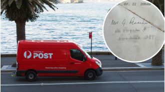 Woman perplexed by one detail on envelope.