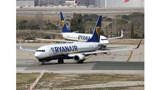 People leave plane due to flames on airport road