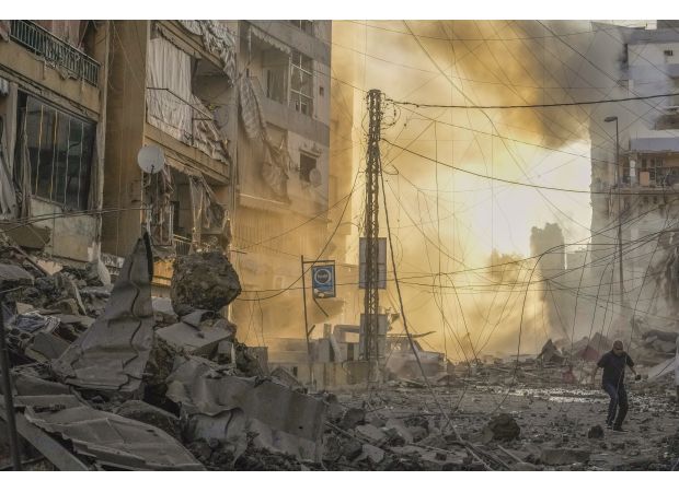 Israel's bombings in Beirut cause major destruction and block a critical passageway to Syria.