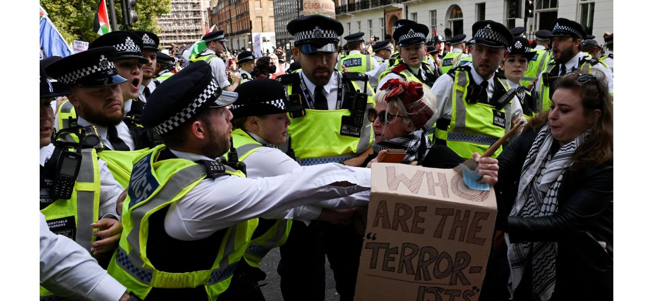 Thousands of protesters in London confront police barrier following large demonstration in city center.