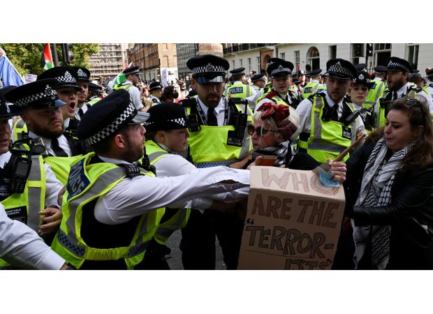 Thousands of protesters in London confront police barrier following large demonstration in city center.