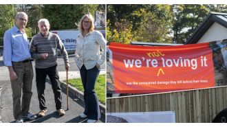 Woman expresses discontent with McDonald's by displaying banner near restaurant.