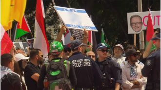 Australian restaurant owner facing charges for displaying a swastika at a protest supporting Palestine.