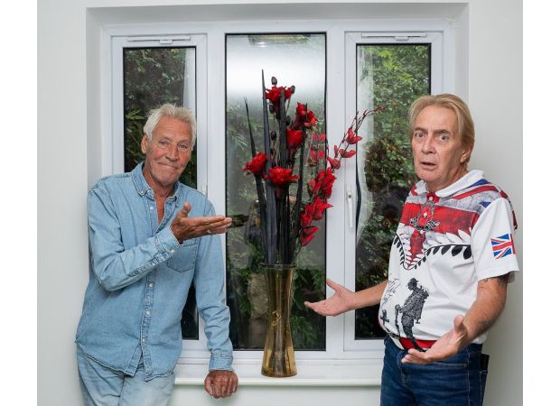 Elderly individuals argue over fake flowers.