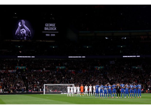 Players from England and Greece honor George Baldock at Wembley Stadium following his untimely passing.