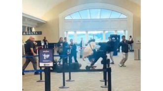 Airline customer threatens to 'kill' cops after jumping behind check-in counter.