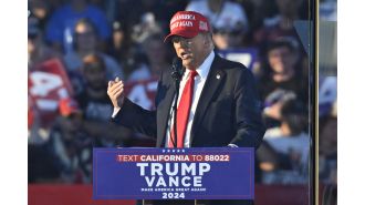 A man with weapons was taken into custody near a rally for Donald Trump.