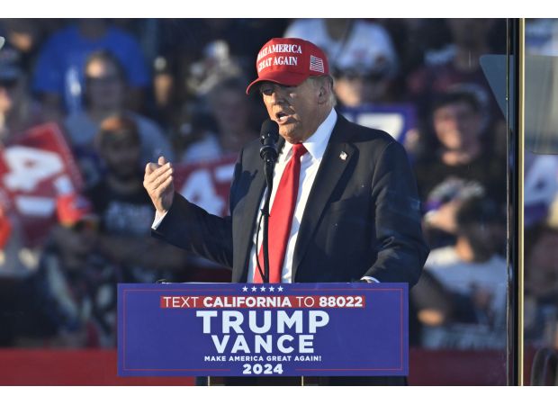 A man with weapons was taken into custody near a rally for Donald Trump.