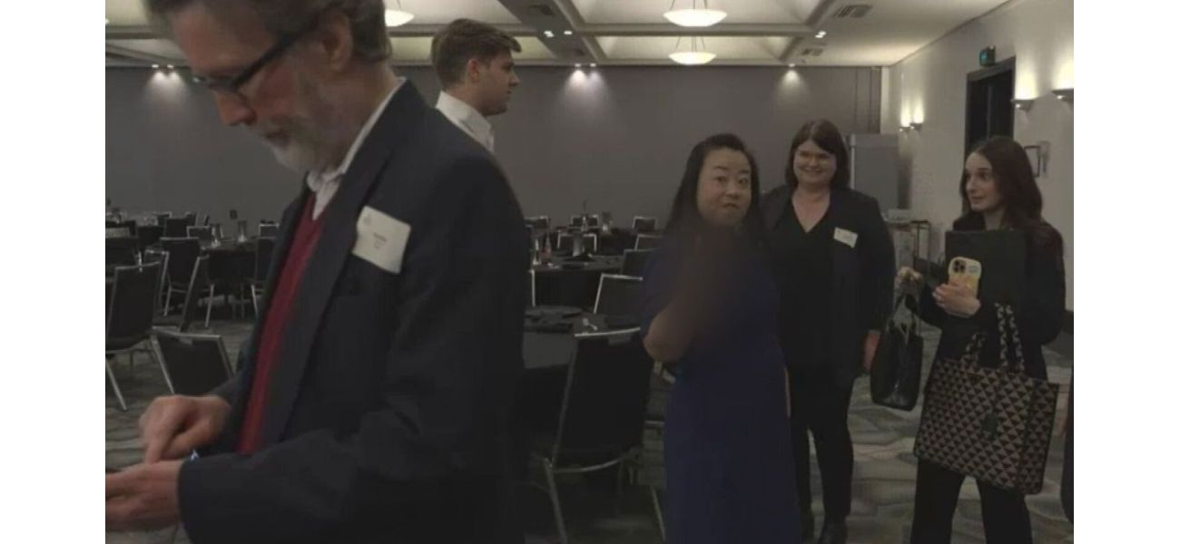 Elderly member of political party expresses offensive gesture towards reporter.