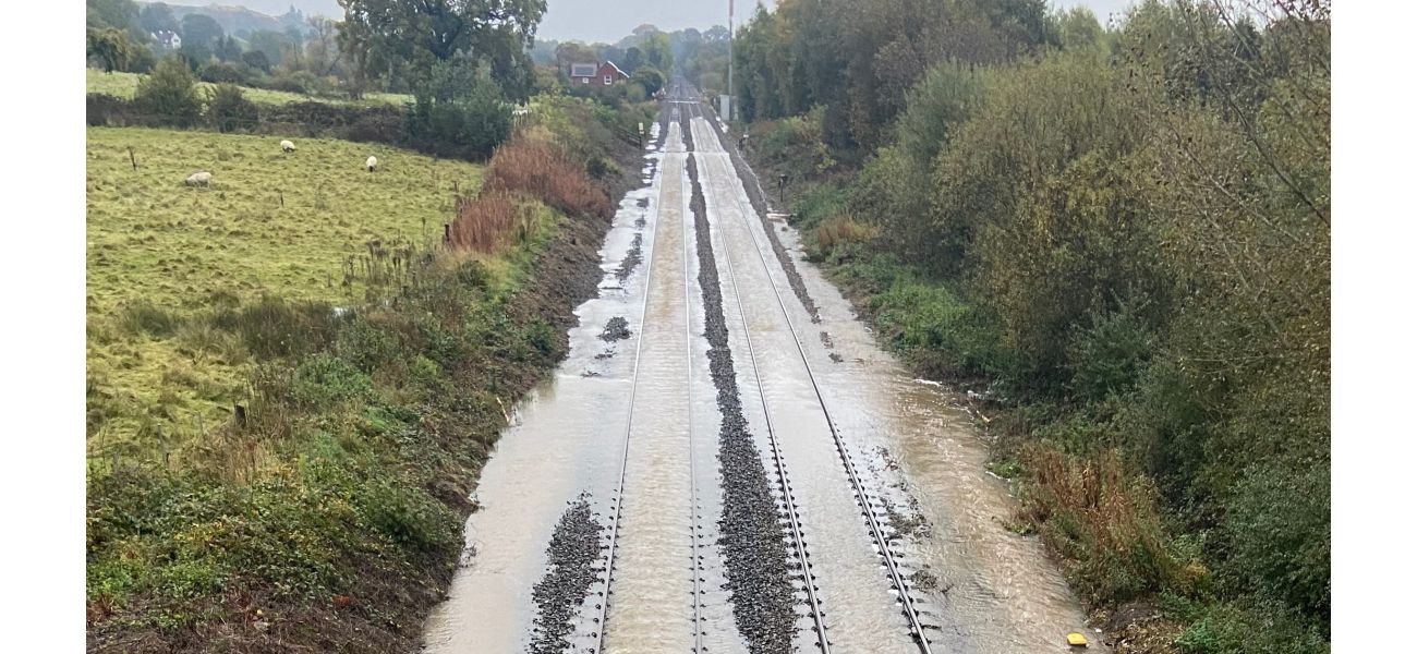 Travel disruptions due to flooding from heavy rain causing chaos on trains and roads in the morning.