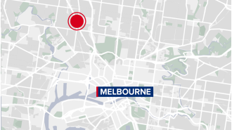 A woman is being sought for stabbing a man at a business in Melbourne.