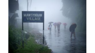 The wettest spot on Earth where people live in stilt houses and use full-body umbrellas.