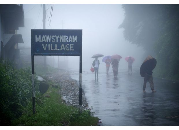 The wettest spot on Earth where people live in stilt houses and use full-body umbrellas.