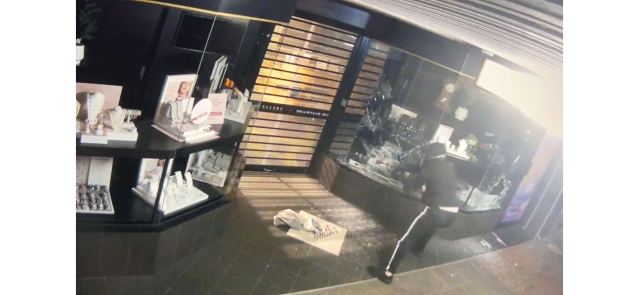 Video footage shows man breaking into old jewelry store with axe.