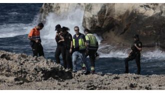 A British tourist died after being dragged into the ocean while taking a stroll in Menorca.