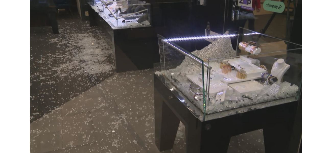 Employees at a jewellery store use a ring-sizing tool to chase away thieves.